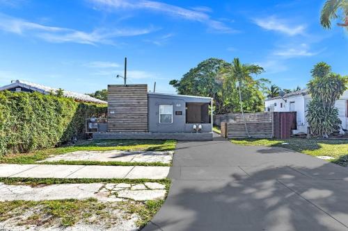 a house in the suburbs with a driveway at Two Bedroom Hollywood Beach Vacation Sc01 in Hollywood