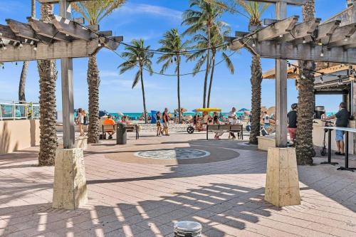 a beach with palm trees and people walking on the beach at Two Bedroom Hollywood Beach Vacation Sc01 in Hollywood