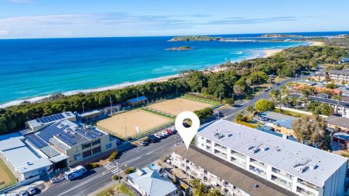 an aerial view of a beach and the ocean at Ocean Echoes Coffs Harbour- Short walk to the beach, Cafes and clubs! in Coffs Harbour