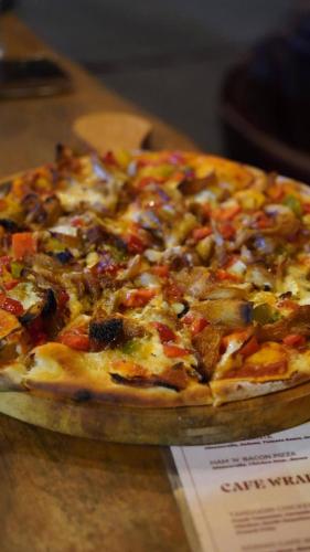 a pizza sitting on top of a table at Beyond Nomad Luxury Hostel in Ella