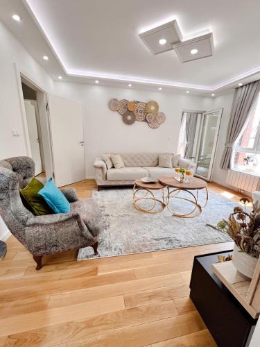 a living room with a couch and a table at Fontana apartmani 1 FREE parking in Tuzla