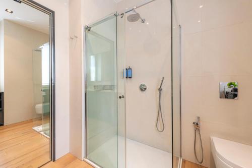 a glass shower in a bathroom with a sink at Milan Royal Suites - Centro in Milan