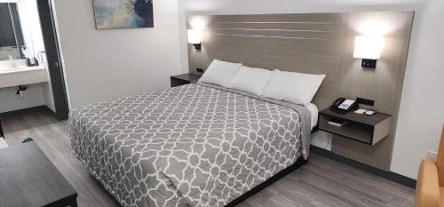 a hotel room with a bed and a sink at Country Inn Banning in Banning