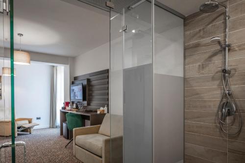 a bathroom with a shower with a glass door at Charm Boutique Hotel in Satu Mare