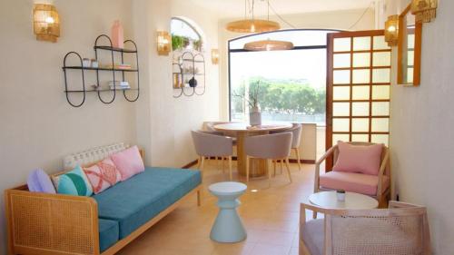 a living room with a blue couch and a table at WOT Sintra Ocean in Sintra