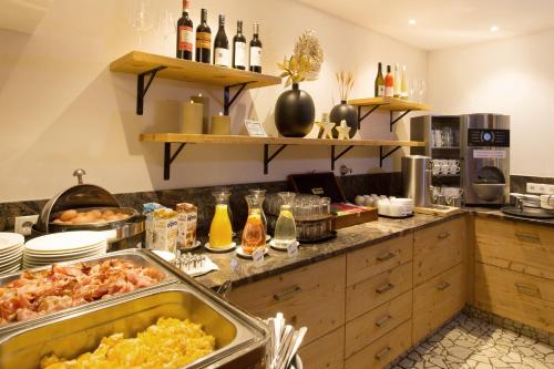 a kitchen with a buffet with a lot of food at Ferienhotel Bergland in Arzl im Pitztal