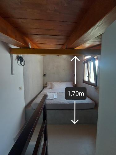 a small room with a bed with a clock on it at Kasteli loft apartment in Kissamos
