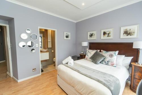 a bedroom with a large bed with a wooden headboard at Endless Summer Coastal Condo in Summerstrand