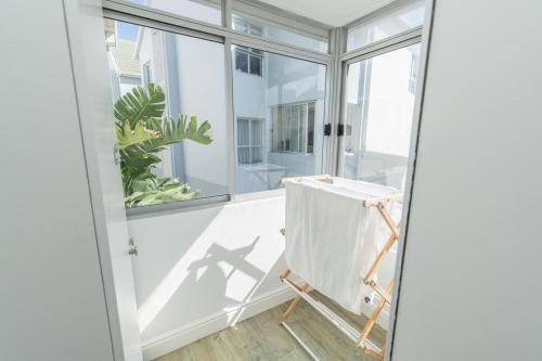 a room with a window and a painting easel at Luxury On The Beach in Summerstrand