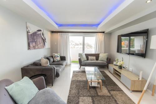 a living room with a blue ceiling at The Pearls 2nd Floor Luxury Apartment in Port Elizabeth