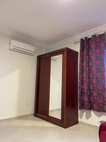 a mirror in the corner of a room with curtains at الساحل الشمالي in El Alamein