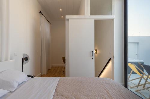 a bedroom with a bed and a sliding glass door at 1924 Gemini House Jacuzzi, Garden, Rooftop in Nicosia