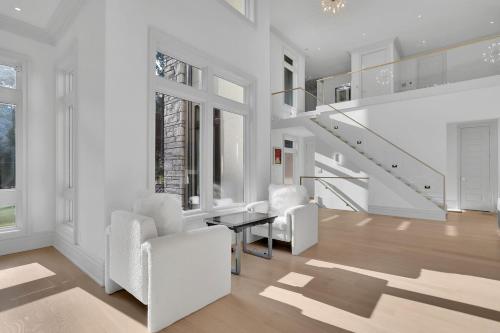a white living room with white chairs and a table at Atl Royal in Atlanta