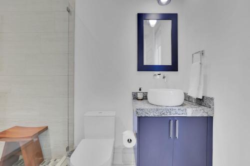 a bathroom with a sink and a toilet and a mirror at Atl Royal in Atlanta