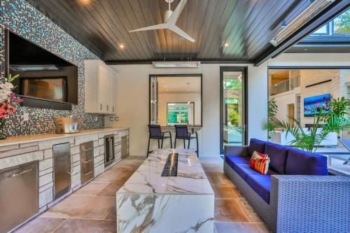 an open kitchen and living room with a blue couch at Atl Royal in Atlanta