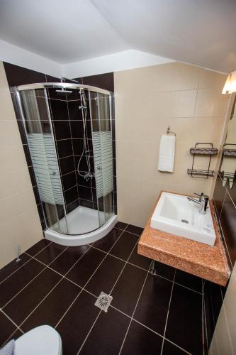 a bathroom with a shower and a sink at Ammolithos Beach in Stavros