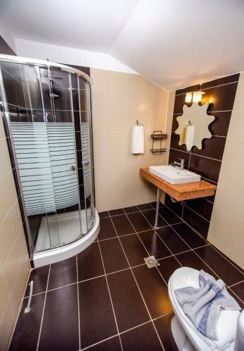a bathroom with a shower and a sink at Ammolithos Beach in Stavros