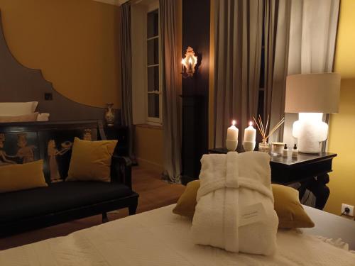 a hotel room with a bed with towels on it at La Divine Comédie-Suites Deluxe in Avignon