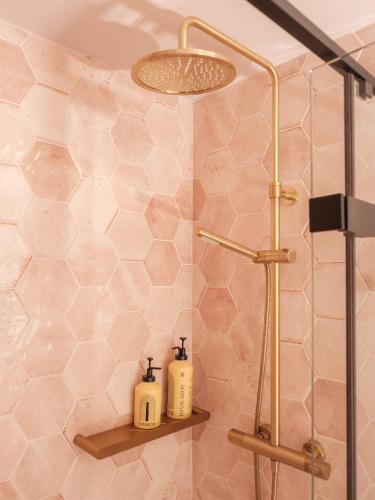 a shower with two soap bottles on a shelf in a bathroom at The Old Winery Cottage No2 in Shepton Mallet