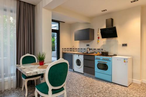 a kitchen with a table and a dining room at Wolf Suites in Antalya