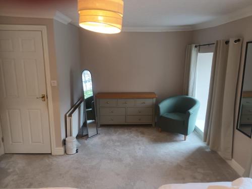 a bedroom with a desk and a chair and a window at Llanina Arms in Llanarth
