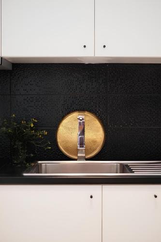 a kitchen with a sink with a wooden spoon at ZEN Minimal Luxury Housing Tyros in Tiros