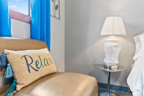a room with a chair and a table with a lamp at Shaligohomes On 16th Ave in Anchorage