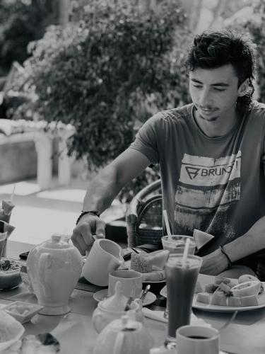 a man standing at a table with plates of food at Maritime Nest Cabanas in Tangalle