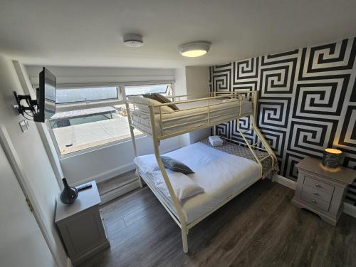 a bedroom with a bunk bed and a window at Stylish City Centre Hideaway & Private Hot Tub in Galway