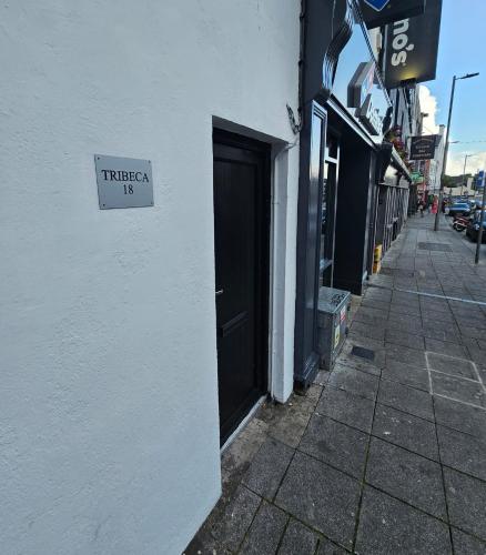 a sign on the side of a building next to a door at Stylish City Centre Hideaway & Private Hot Tub in Galway