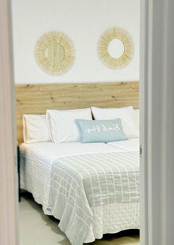 a bedroom with a bed with two mirrors on the wall at D'Sal y Arena in Breña Baja