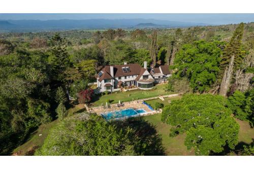 an aerial view of a house with a swimming pool at Ol Endeti House in Kuhora Twana