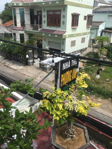 a sign in front of a house with a plant at Motel phương anh in Phan Thiet