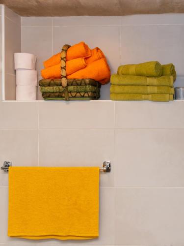 a shelf with towels and a towel in a bathroom at 75 St Christopher Street, Valletta in Valletta