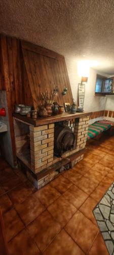 a brick fireplace in a living room with at Waterfall Guest House in Ribarica