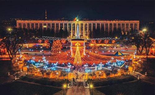 a large building with lights in front of it at night at Vasile Alecsandri 60 ap 49 in Chişinău
