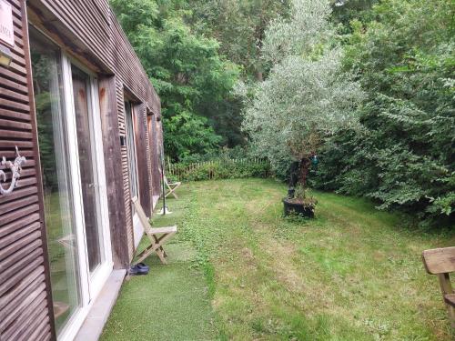 a window of a house with a tree in the yard at Lake Harelbeke in Harelbeke