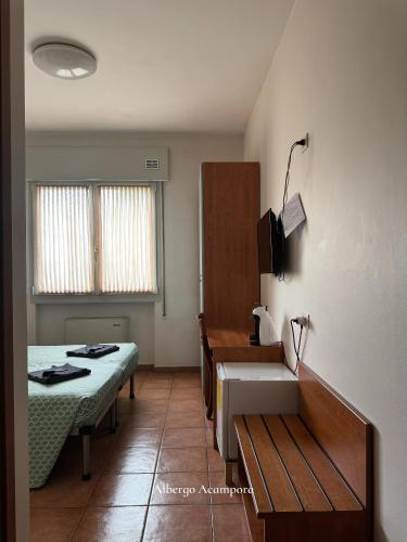 a room with a bed and a sink in it at Albergo Acampora in Vicenza