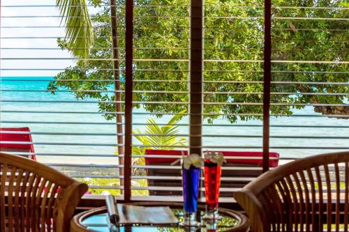 a table with a blue vase on top at Crystal Bay Yacht Club Beach Resort in Lamai