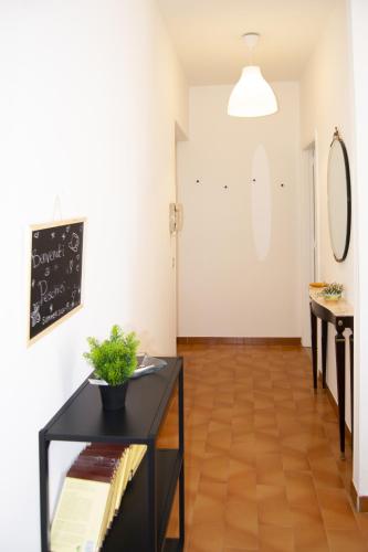 a living room with a black table and a chalkboard at Peschici Central Room - vista mare in Peschici