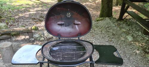 a grill with a face on top of it at Slovak cottage near Bratislava in the heart of the Carpathians in Modra
