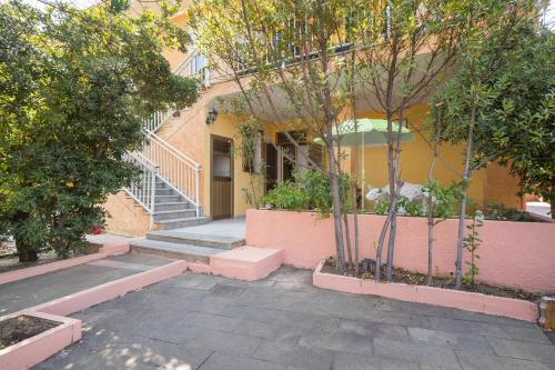 a building with stairs and trees in front of it at Casa Monica in Posada