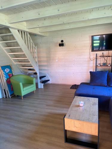 a living room with a blue couch and a table at Siemianówka in Siemiany