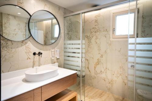 a bathroom with a sink and a mirror at Iberostar Selection Creta Marine in Panormos Rethymno