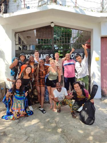 a group of people posing for a picture in front of a building at HOMELAND SWAHILI LODGE Nungwi Backpacker Apartments BUDGET in Nungwi