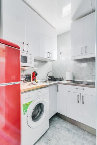 a white kitchen with a washing machine in it at Home2Book Stunning BeachFront Apt, Pozo Izquierdo in Pozo Izquierdo