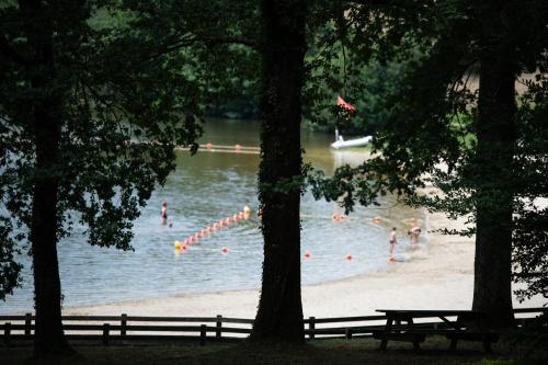 a group of people swimming in a body of water at Flower Camping de Rouffiac in Angoisse