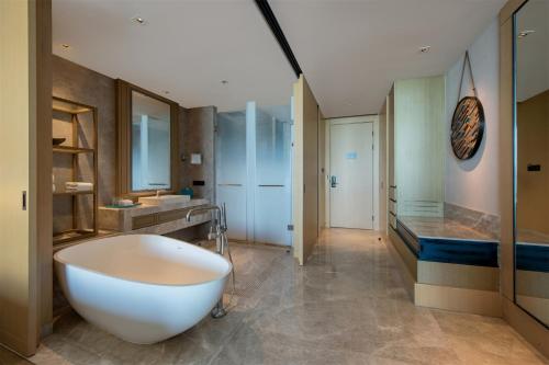 a large bathroom with a large tub and a sink at DoubleTree by Hilton Shanwei in Shanwei
