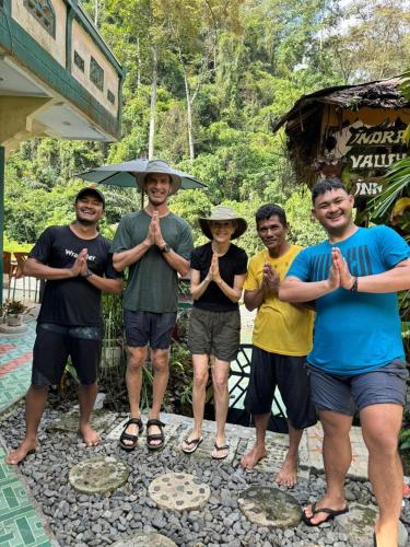 a group of people standing together with their hands up at Indra Valley Inn Bukit Lawang in Bukit Lawang