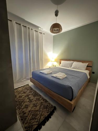 a bedroom with a bed with a blue comforter at La casa in Chios